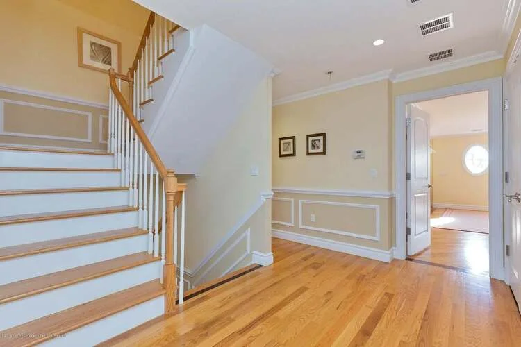 Hardwood floors complemented by an elegant staircase.