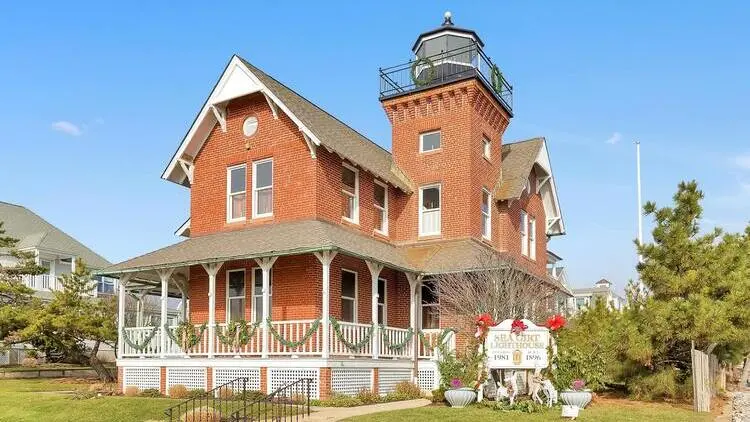 Exterior photo of the historic Sea Girt Lighthouse, a landmark symbolizing the area's maritime heritage.